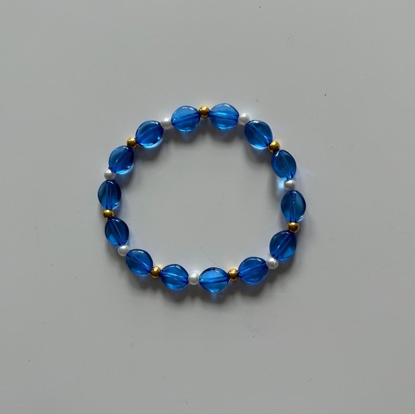 Blue beaded bracelet with gold accent