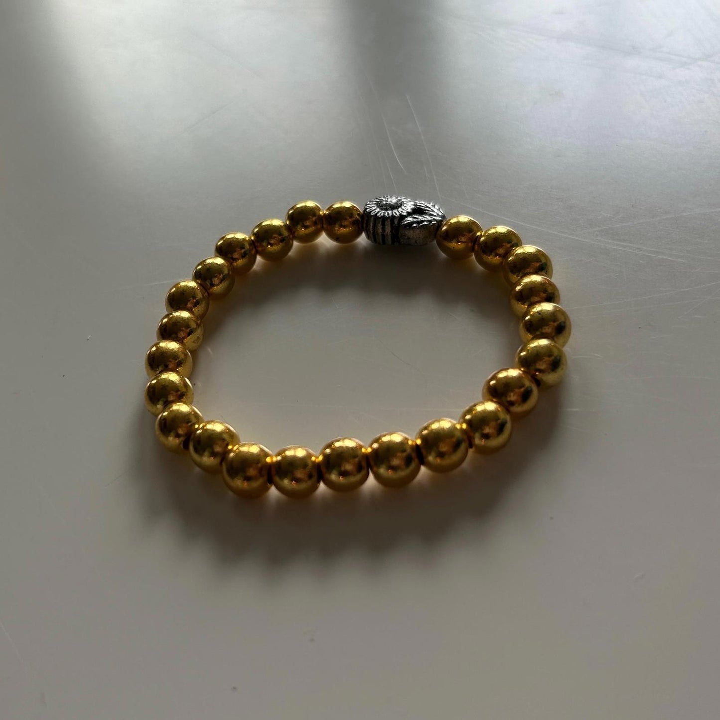 Gold Beaded Bracelet with Silver Sun Charm