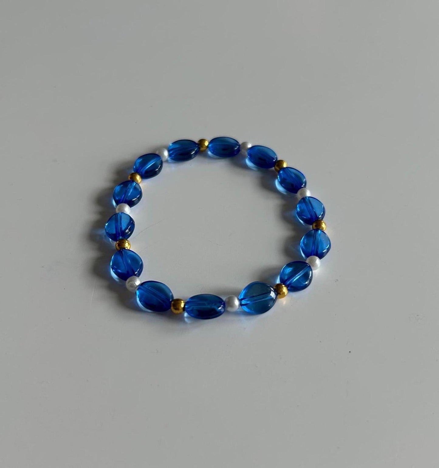 Blue beaded bracelet with gold accent